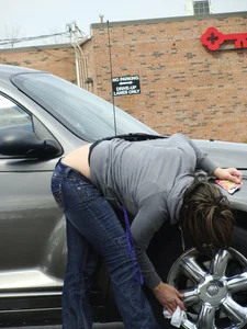Girl cleaning her car in jeans and showing some cheetah print underwear