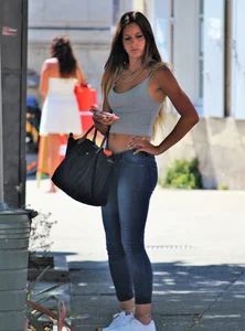Sexy blonde girl in tight jeans and showing midriff