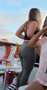 Blonde bending over on a boat in leggings