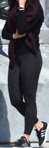Brunette with glasses on the phone in tight patterned leggings