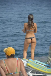 Sexy skinny babe in thong bikini on the beach