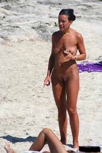 Smoking milf at a nude beach with a hairy pussy