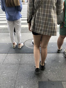 Closeups of a gorgeous girl wearing spandex mini shorts crossing the street