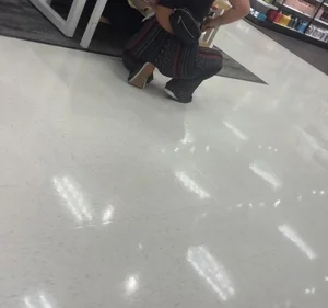 White girl in flare pants bending over