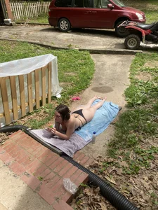 Topless hottie sunbathing in her backyard
