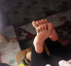 Young Girl's Bare Feet Selfies in Bed