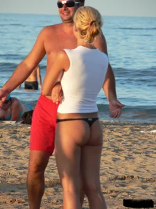 A bunch of hot babes on the beach in thong bikinis