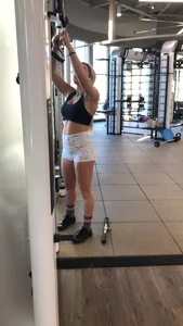 Hot blonde working out at the gym in shorts and crop top