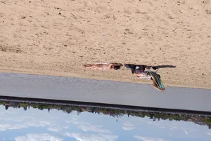 Girl laying out getting sun in a white thong bikini