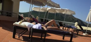 Blonde laying out in a blue bikini with a sexy body