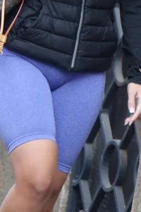 Wide hipped, juicy fronted tanned brunette pawg struts in lycra shorts