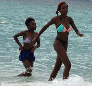 Candid black family, milf and teens on the beach in bikinis