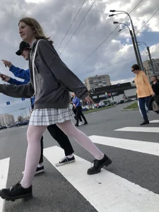 Candid teen girl wearing a skirt and white pantyhose crossing the street creepshots