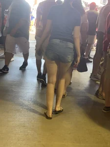 Bunch of girls in various outfits at a Cardinals baseball game