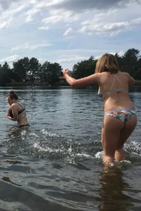 Big boobed babe at the lake in a black thong with blonde friend