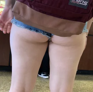 Yummy big booty hanging out for everyone to see in denim shorts