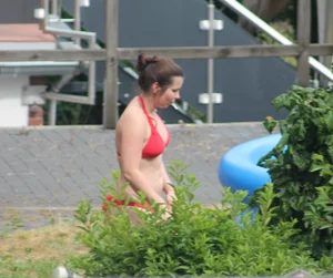 Thick babe in the backyard in red bikini