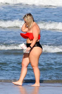 Thick BBW blonde lady in a bikini at the beach