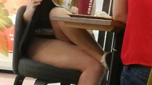Teen Sitting with Crossed Legs and Pulling her Skirt Up - Cafe Creepshot