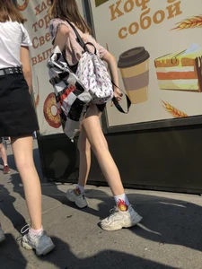 Couple of Skinny Girls in Mini-Skirts And Sneakers Street Photos