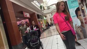 Little blonde teen in grey leggings at the mall with her friends