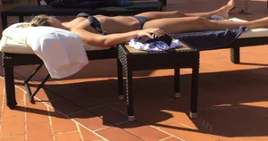 Blonde laying out in a blue bikini with a sexy body