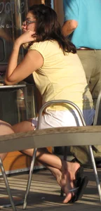 Lady in flop flops while eating showing her feet