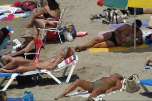 Girls on a nude beach in Sitges, Spain