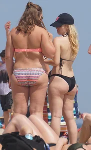 Two thick white girls in bikinis on the beach with big asses
