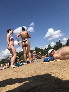 Gorgeous milf rubbing sun lotion in her skin at the beach, with a couple of her milf friends