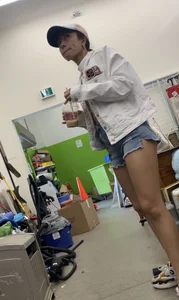 Tight bum hanging out of jean shorts in thrift shop