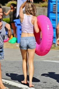 Tubing hottie in shorts and a wet white shirt