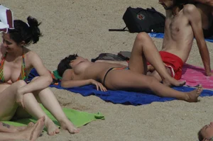 Topless girls on a beach in Barcelona
