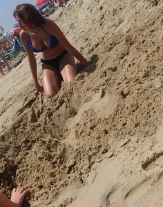 Girl with great tits playing in the sand at the beach