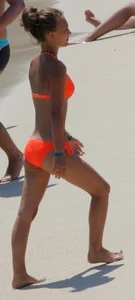 Blonde teen on the beach in orange bikini