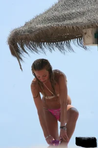 Hot beach girl undressing and going topless