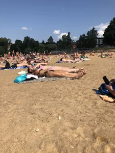 Gorgeous milf rubbing sun lotion in her skin at the beach, with a couple of her milf friends