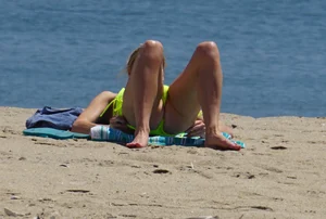 Sexy ass blonde milf on the beach in a thong with cameltoe and bending over