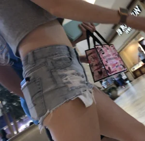 Sexy Flat Booty and Legs - Girl in a Top and Denim Mini Shorts at the Mall Closeup Creepshot