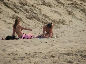 Topless beach girl with nice titties with her friend in a bikini