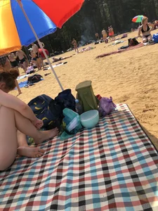 Skinny Girl in a Black Swimsuit at a Beach