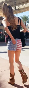 Cute girl with glasses in USA shorts showing her cheeks