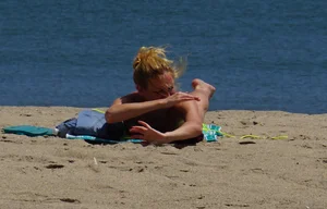 Sexy ass blonde milf on the beach in a thong with cameltoe and bending over