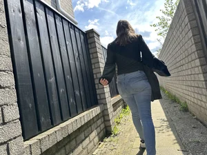 Sexy girl in tight blue jeans walking down a suburban street creepshots