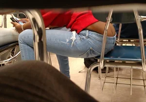 Hot Girl in Tight Jeans Sitting on Chair Bending Over