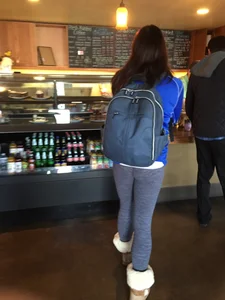 Cute Girl in Blue Tights With a Backpack in a Cafe Creepshot - Booty Closeup