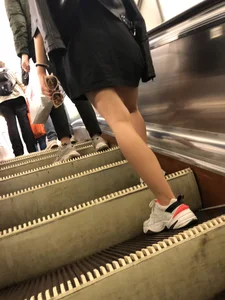 Blonde in a Dress and Sneakers With Sexy Skinny Legs in the Subway Train and on the Escalator Closeup Candid Photos