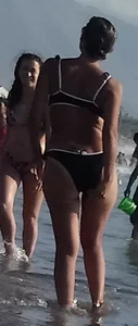 Milf with a big booty in a bikini at the beach