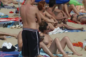 Topless girls on a beach in Barcelona
