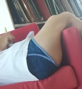 Candid Girl in Mini Shorts Curled Up in the Couch at the Library